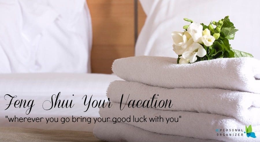 A stack of neatly folded white towels with a small bouquet of white flowers placed on top sits on a bed. The text reads "Feng Shui Your Vacation" and "wherever you go, bring your good luck with you." A logo for "A Personal Organizer" is seen in the bottom right corner, adding a touch of Thanksgiving charm.