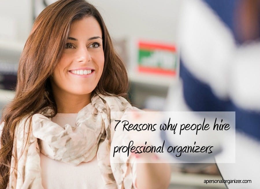 A smiling woman with long brown hair and a light-colored scarf sits in a professional setting. Overlaid text reads "7 Reasons why people hire professional organizers." The website "apersonalorganizer.com" is visible in the bottom right corner, highlighting the benefits of professional organizing.