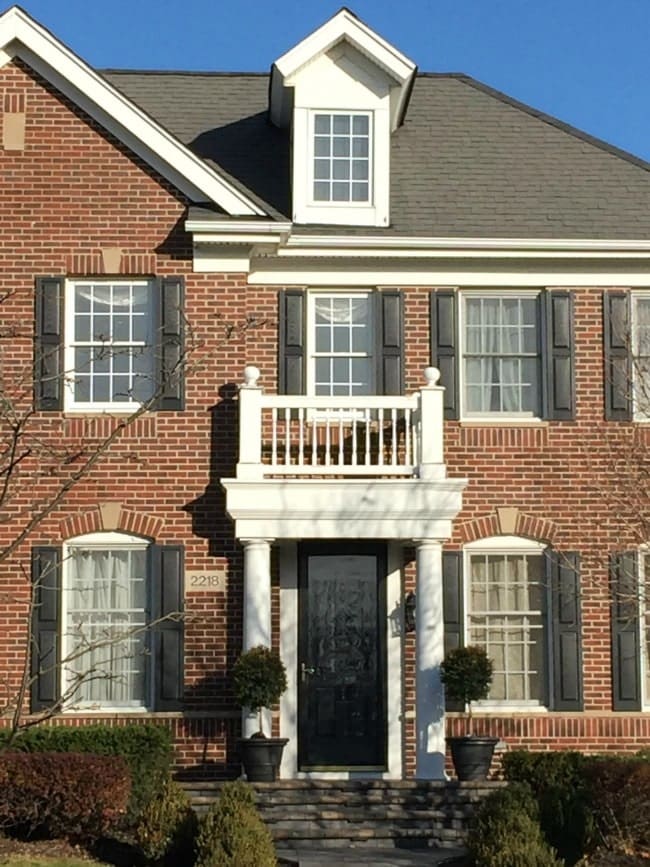 Brick house with black shutters white trim