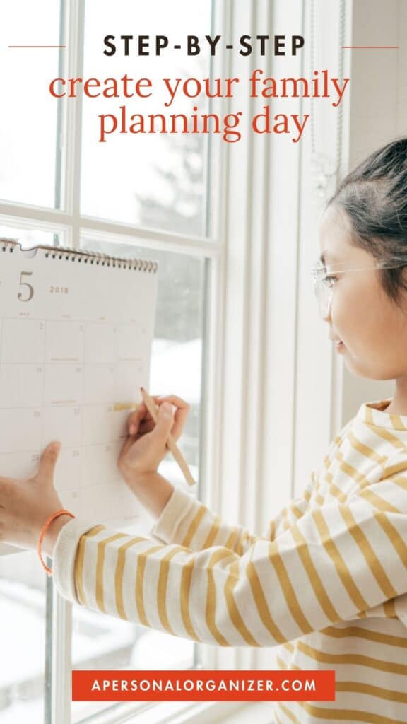 Girl writing on a wall calendar