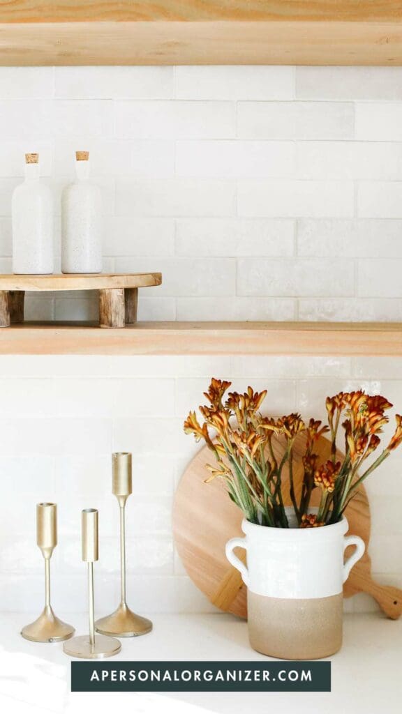 kitchen counter with white backsplash, autumn flowers
