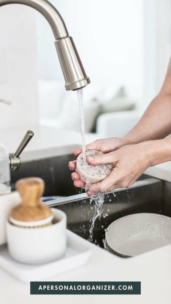 Woman washing dishes | APersonalOrganizer.com